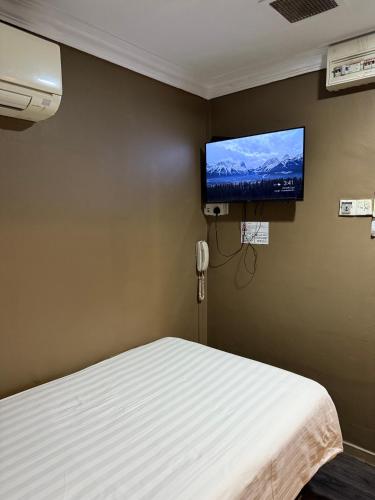 a hospital room with a bed and a flat screen tv at HOTEL JJH Aliwal in Singapore
