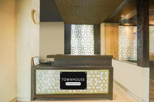 a room with a table with a tumulus sign on it at Super Townhouse Sikar Road Jaipur Formerly Hotel Aroma Inn in Jaipur