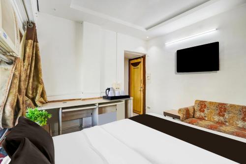 a hotel room with a bed and a couch at Super Collection O Maninagar East Formerly Maninagar Residency in Ahmedabad