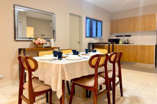 a dining room with a table with chairs and a mirror at Alanis Suite With Netflix @ KLIA Sepang in Sepang
