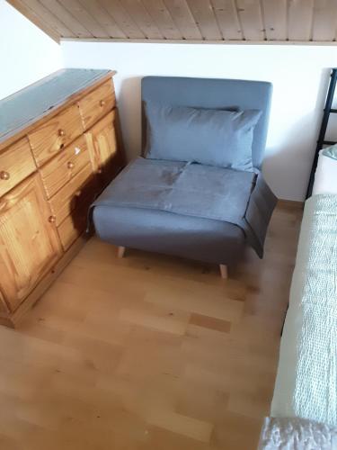 a futon bed in a bedroom with a dresser at Hausveronika in Mariapfarr