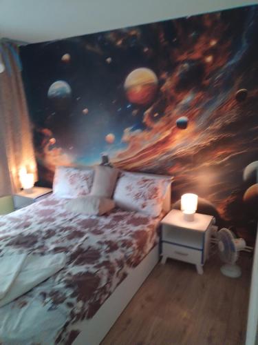 Un dormitorio con un cuadro de planetas y una cama. en Children room Hunedoara, en Hunedoara