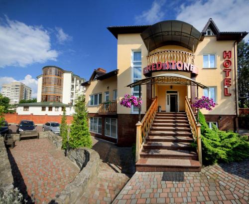 a red stone building with a sign on it at Red Stone in Truskavets