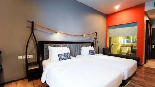 a bedroom with a large white bed and a mirror at Mercure Surabaya Grand Mirama in Surabaya