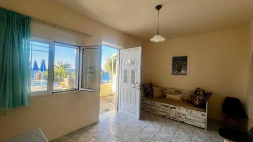 SellíaにあるSouda Bay Apartmentsのドアと窓のある部屋、ソファが備わる部屋