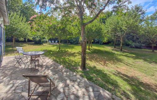 a patio with a table and chairs in a park at Amazing Home In Névez With Wifi in Névez