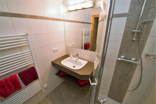 a bathroom with a sink and a shower at Ferienhaus Franz in Weissbriach