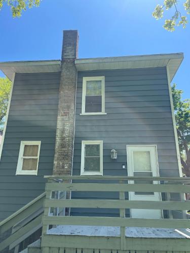 a house with a chimney on the side of it at Spacious 1 Bedroom Duplex in Lansing