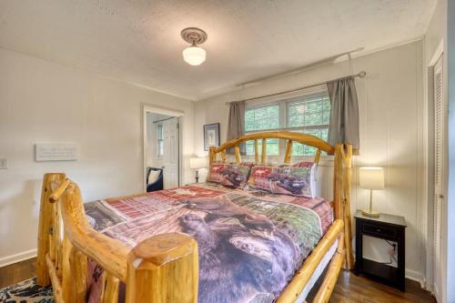 a bedroom with a wooden bed and a window at Nature Sounds Retreat in Boone