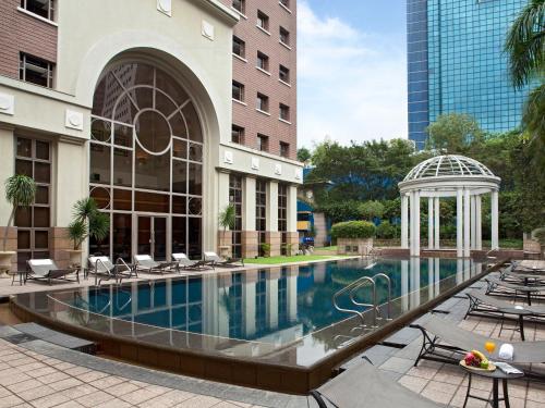 a swimming pool in a building with a gazebo at Orchard Parksuites by Far East Hospitality in Singapore