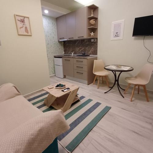 a living room with a couch and a table at Central Modern Living Apartment 1 in Eleftheroúpolis