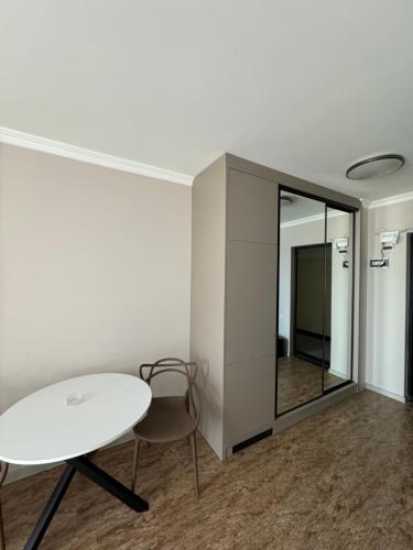 a white room with a table and a mirror at Pirosmani Mini Hotel in Batumi