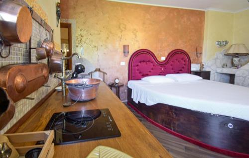 a bedroom with a bed and a counter with a stove at Stunning Apartment In Monteleone Sabino With Wifi in Monteleone Sabino