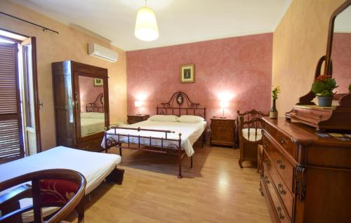 a bedroom with a bed and a dresser and a mirror at Stunning Apartment In Monteleone Sabino With Wifi in Monteleone Sabino