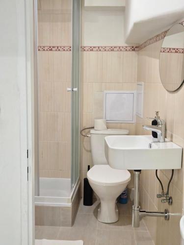 a bathroom with a toilet and a sink and a shower at Apatments Prague by Yuliia in Prague