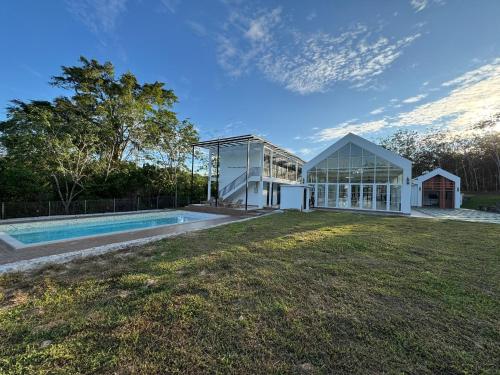 a house with a swimming pool in the yard at The Outskirt Melaka in Kampong Lendu