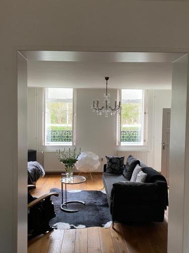 a living room with a couch and a table at B&B de Tol in Hulst