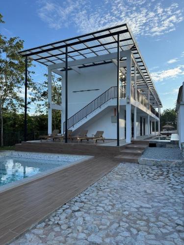 a building with a staircase and a swimming pool at The Outskirt Melaka in Kampong Lendu
