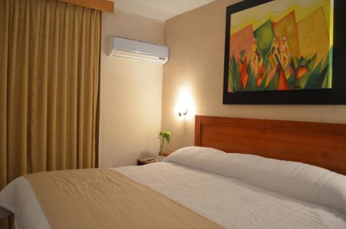 Ein Bett oder Betten in einem Zimmer der Unterkunft Hotel Mesón de la Chinantla
