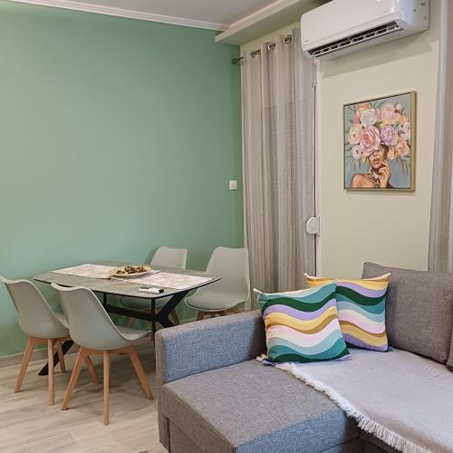 a living room with a couch and a table at Central Modern Living Apartment 2 in Eleftheroúpolis