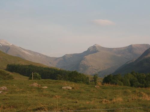 a green field with mountains in the background at Stob-Ban View - S4582 in Fort William