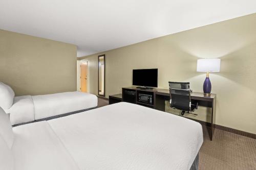 a hotel room with a bed and a desk with a computer at Sleep Inn Boone University Area in Boone