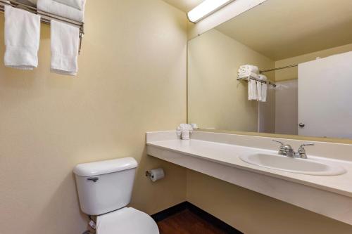 a bathroom with a toilet and a sink at Suburban Studios Albuquerque Uptown in Albuquerque