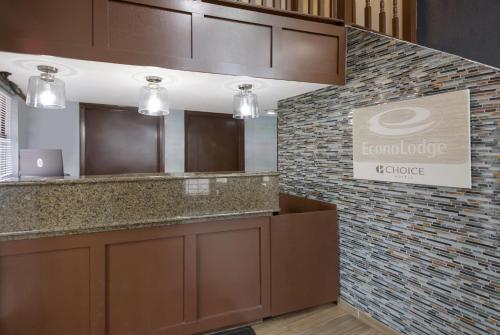 a lobby with a counter and a sign on a wall at Econo Lodge Austin North near The Domain in Austin