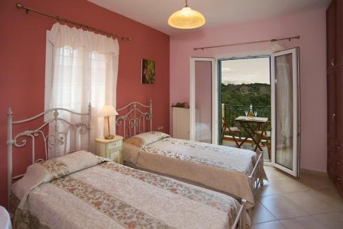 two beds in a bedroom with a balcony at stunning tranquil villa with private pool in Sami