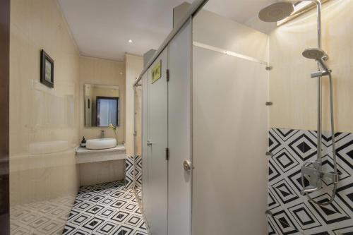 a bathroom with a shower and a sink at Hanoi Traveller House in Hanoi
