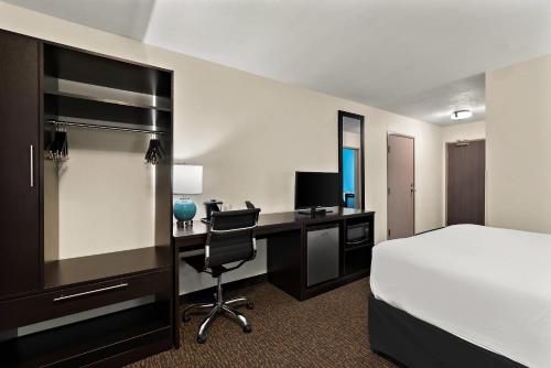 a hotel room with a bed and a desk with a computer at Sleep Inn Kelso Longview in Kelso