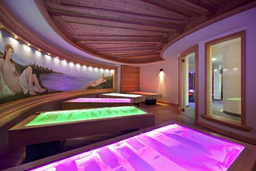 a ping pong room with purple and green lighting at Parc Hotel Miramonti in Fiè