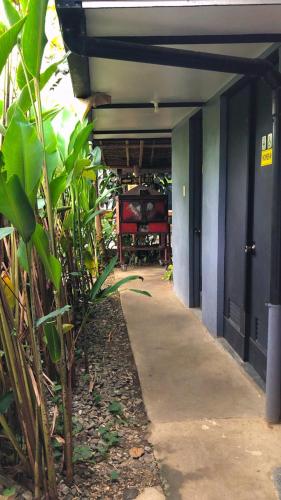 a walkway leading to a room with a table at Cafe Moto Hostel in Puerto Princesa City
