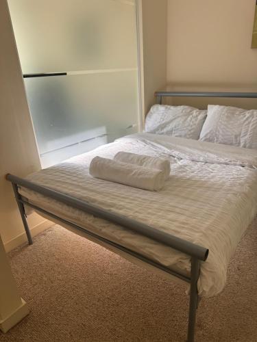 a bed with a pillow on top of it at Lovely cosy flat in Manchester