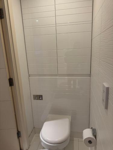 a small bathroom with a toilet and a mirror at Lovely cosy flat in Manchester