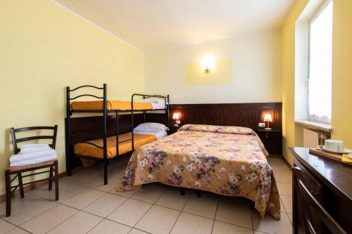 a bedroom with a bed and bunk beds in it at Agriturismo Ceolara in Sommacampagna