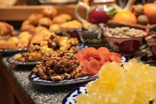 a bunch of different types of food on a table at Sayyoh Hotel in Tashkent
