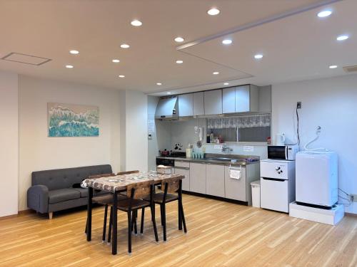 a kitchen and living room with a table and chairs at 晴の浜 in Wakayama