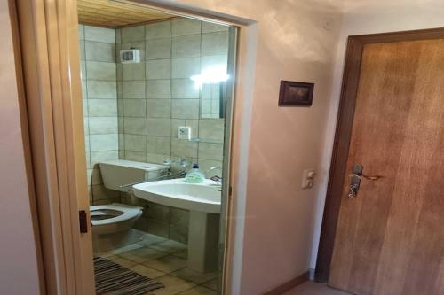 a bathroom with a sink and a toilet and a mirror at Guest House Villa Daniel - Two Bedroom Apartment with Balcony in Omiš