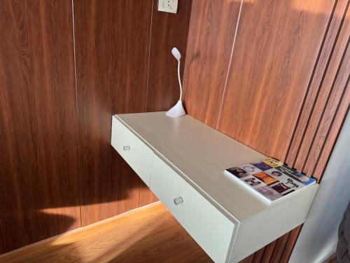 a desk with a white vase on top of it at Nile View Apartment in Zamalek Stays in Cairo