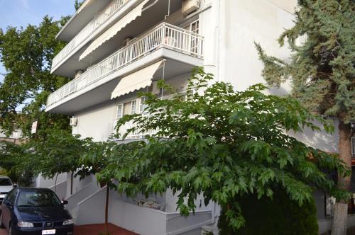 a white apartment building with a balcony at Galanis Studios and Apartments in Platamonas