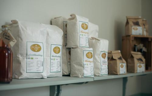 a shelf with bags of coffee on it at Kungälvs Bed & Brekfast in Kungälv