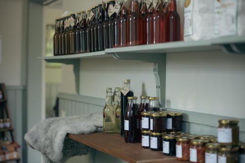 a shelf with bottles of alcohol on it at Kungälvs Bed & Brekfast in Kungälv