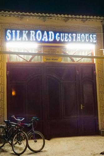 two bikes are parked in front of a building at Silk Road Guest House in Bukhara
