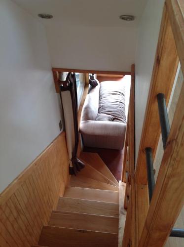 a stairway with a couch and a chair in a room at Martina Bungalows in Ensenada
