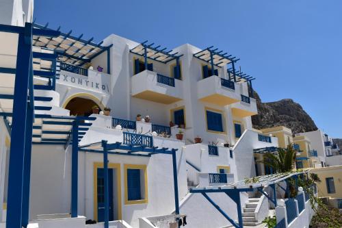 a group of white buildings with blue windows at Arhontiko Hotel in Foinikion
