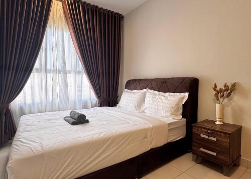 a bedroom with a bed with a hat on it at Alanis Suite With Netflix @ KLIA Sepang in Sepang