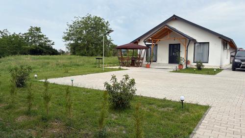 a small house with a car parked in front of it at Palko Residence 2 in Ocna-Mureşului