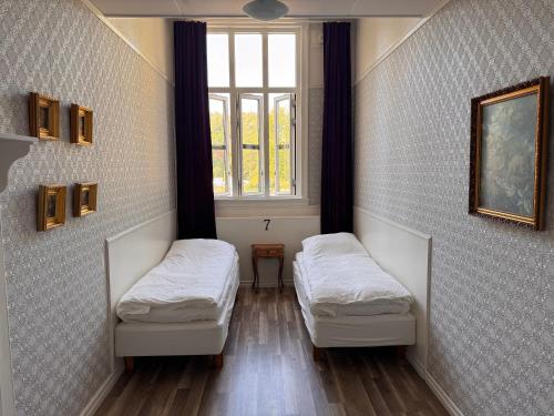 two beds in a room with a window at Kungälvs Bed & Brekfast in Kungälv