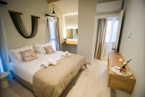 a bedroom with a bed with towels on it at Kalliopi Luxury Apartments in Kalliópi